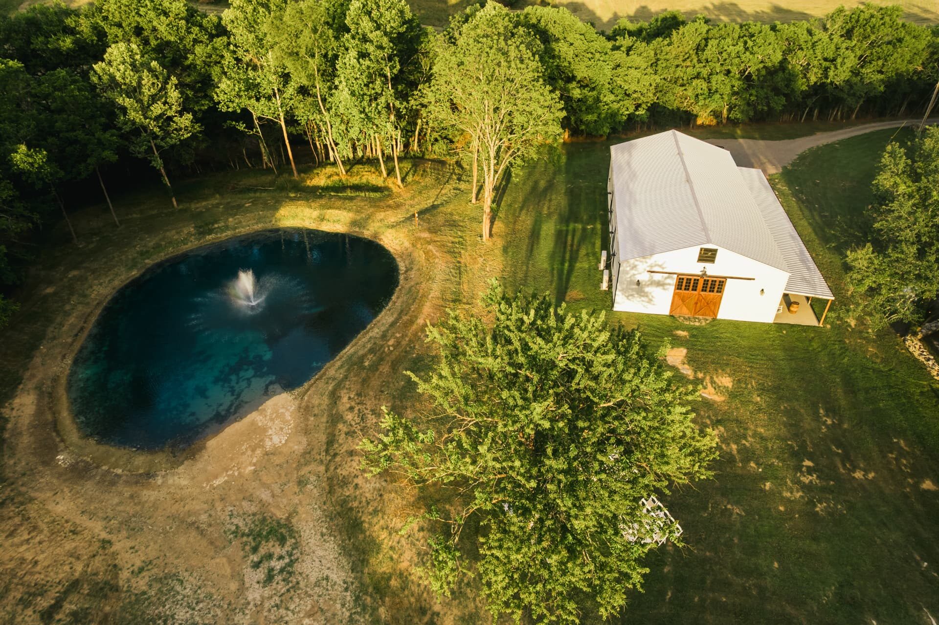 Aerial view of the barn and spring-fed pond with fountain
