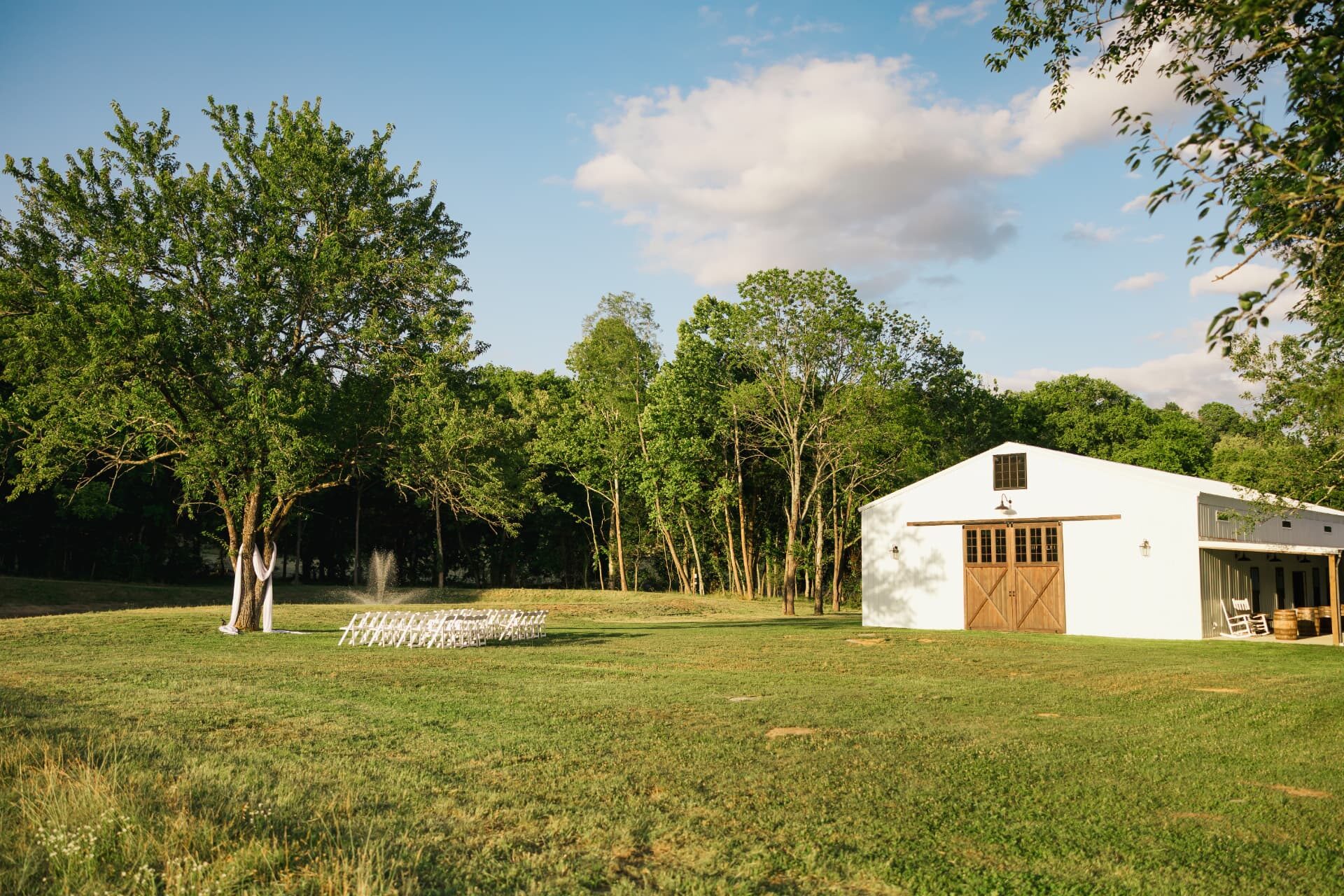 The white barn and ceremony lawn on a summer evening