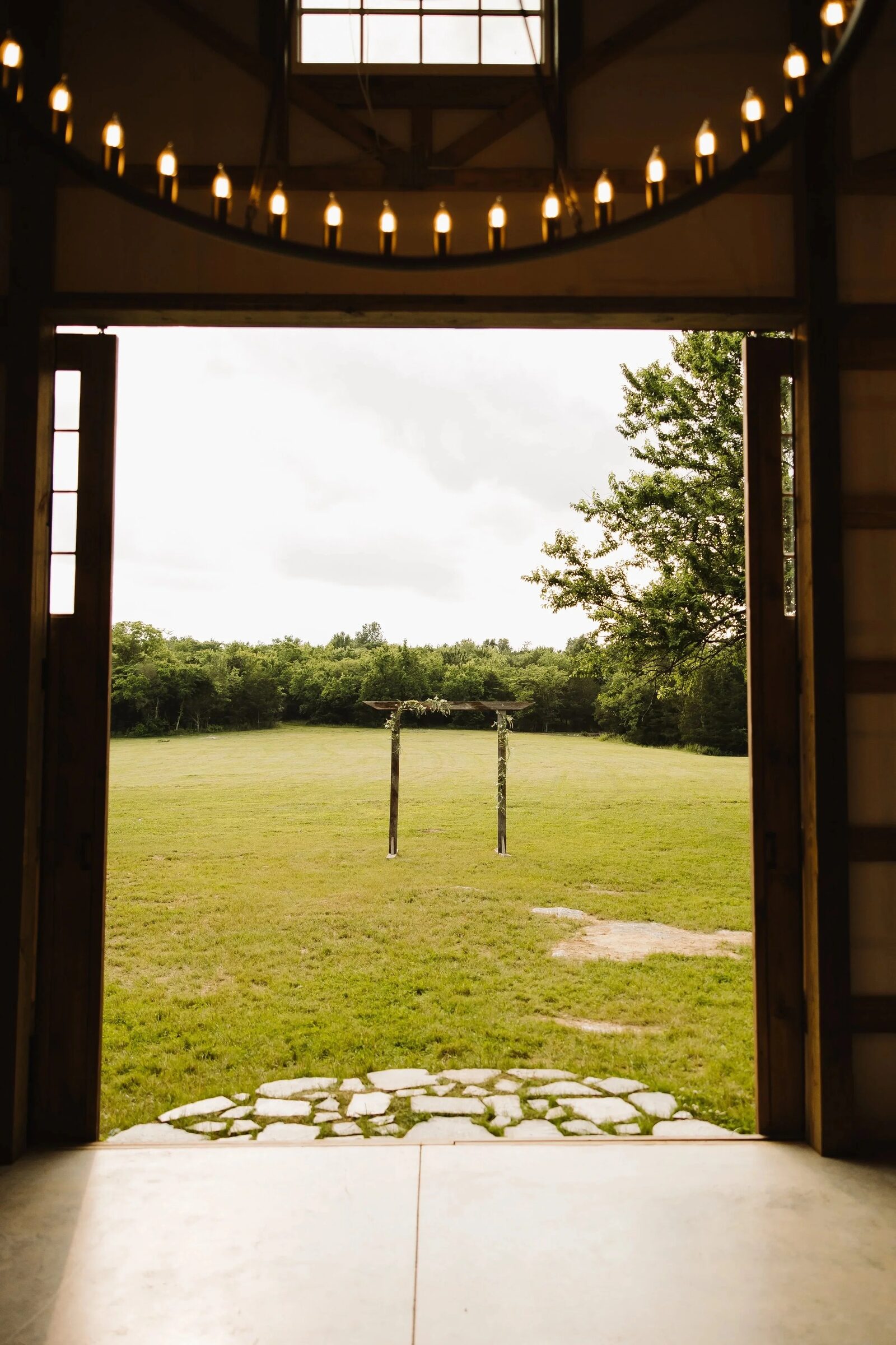Wooden ceremony arbor dressed with drapery and florals